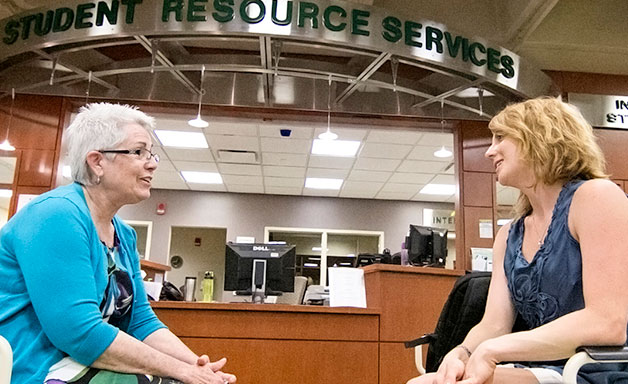 Advisor talking with a student at the Student Resource Center Advisor talking with a student at the Student Resource Center